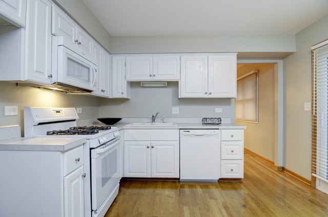 467 Sheffield Road Naperville, IL 60565 - Photo 7 of 19 a kitchen with granite countertop a sink cabinets and wooden floor
