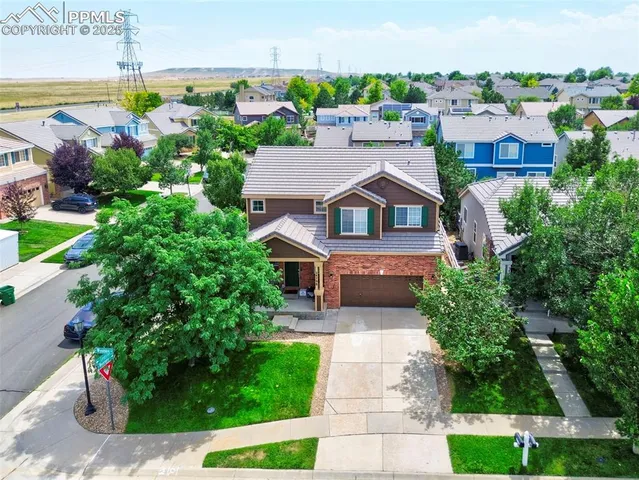 an aerial view of multiple houses with yard