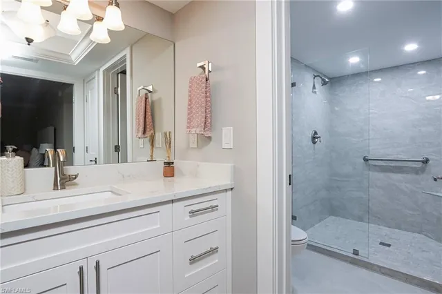 a bathroom with a shower sink and mirror