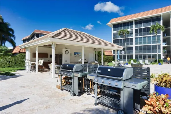 a view of a patio with a dining table and chairs
