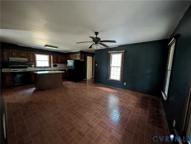 a view of a kitchen with a sink and a stove top oven