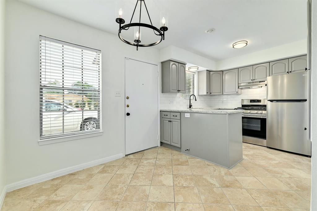 204 Northwest Drive, Unit B Round Rock, TX 78664 - Photo 12 of 25 a kitchen with stainless steel appliances granite countertop a stove a sink dishwasher a refrigerator and a counter space