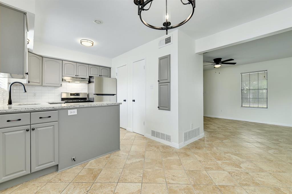 204 Northwest Drive, Unit B Round Rock, TX 78664 - Photo 13 of 25 a kitchen with kitchen island a counter top space appliances and cabinets
