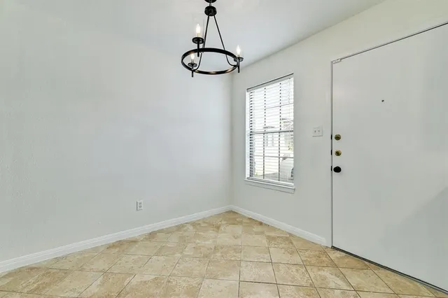 a view of a room with window and chandelier fan