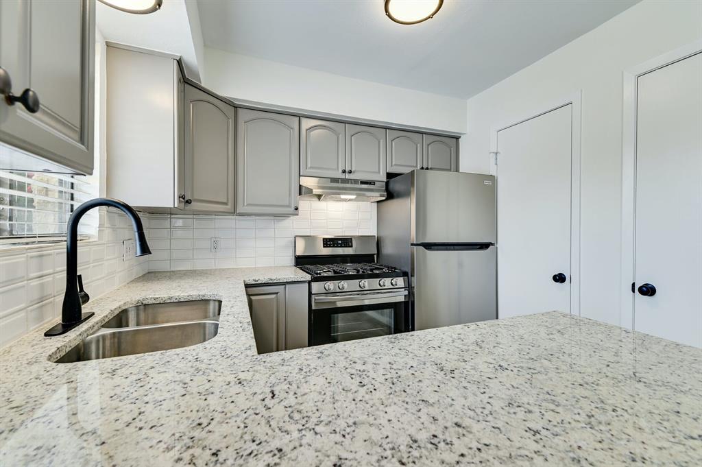 204 Northwest Drive, Unit B Round Rock, TX 78664 - Photo 17 of 25 a kitchen with granite countertop a refrigerator and a sink