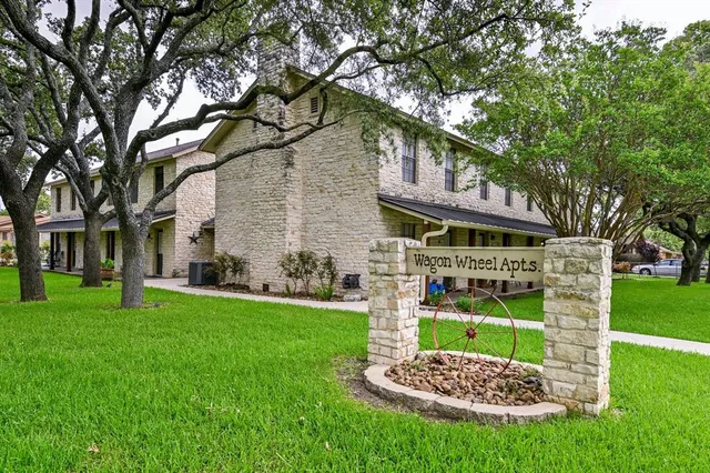 a front view of a house with a yard table and chairs
