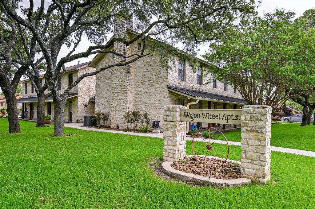 204 Northwest Drive, Unit B Round Rock, TX 78664 - Photo 3 of 25 a front view of a house with a yard table and chairs