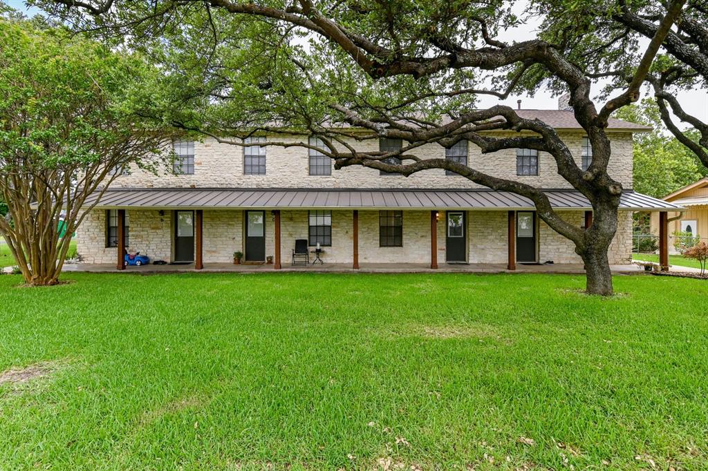 204 Northwest Drive, Unit B Round Rock, TX 78664 - Photo 5 of 25 a view of a brick house with a large windows and a large tree