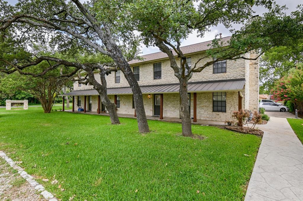 204 Northwest Drive, Unit B Round Rock, TX 78664 - Photo 6 of 25 a view of a yard with table and chairs and a large tree