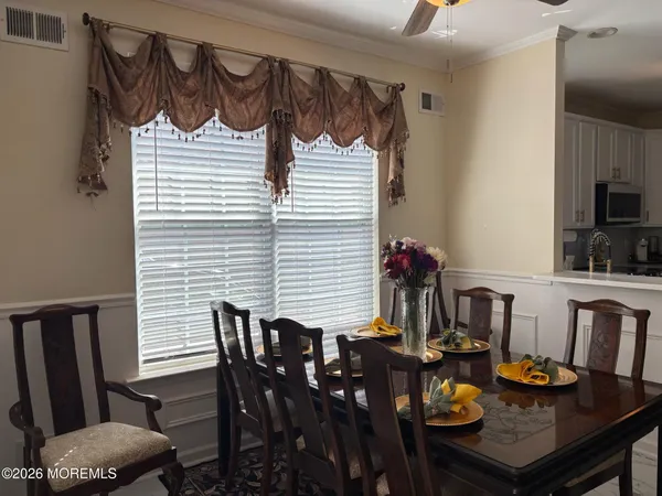 a view of a dining room with furniture and window
