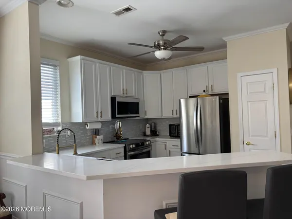 a kitchen with sink cabinets and window