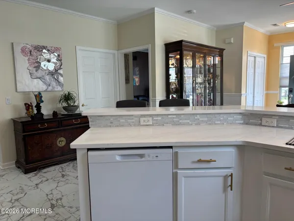 a kitchen with a stove and a white cabinets