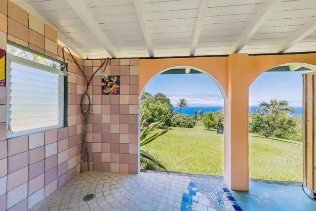 a balcony with wooden floor and outdoor seating