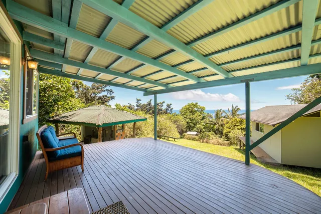 a kitchen with stainless steel appliances granite countertop a stove a refrigerator a sink with wooden cabinets and wooden floor