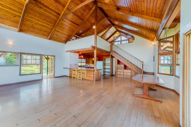 a room with wooden floor and furniture