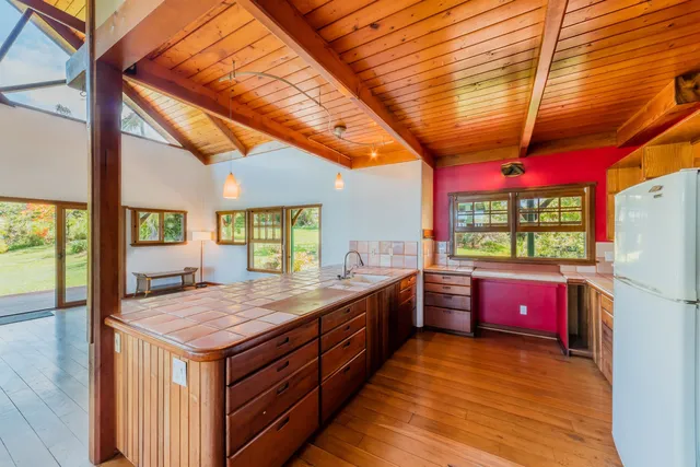 a kitchen with stainless steel appliances granite countertop a stove a refrigerator and wooden cabinets