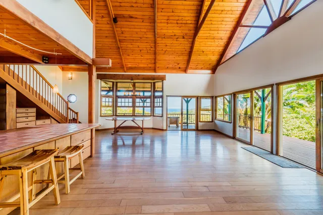 a view of a room with furniture and wooden floor
