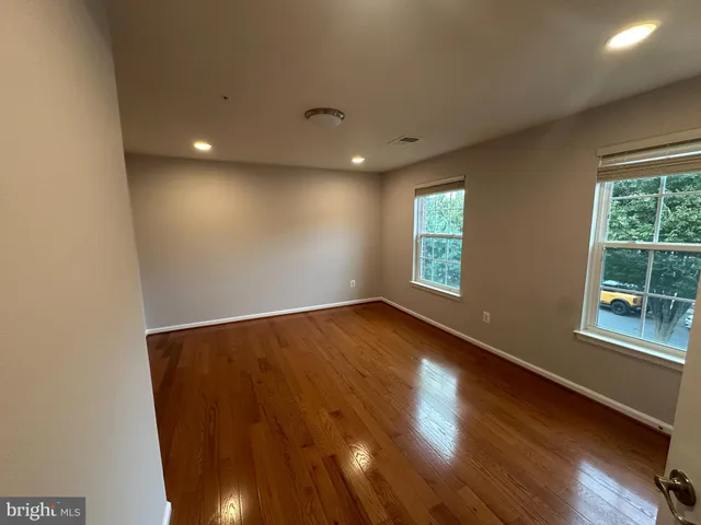 a bathroom with a bathtub shower sink vanity and mirror
