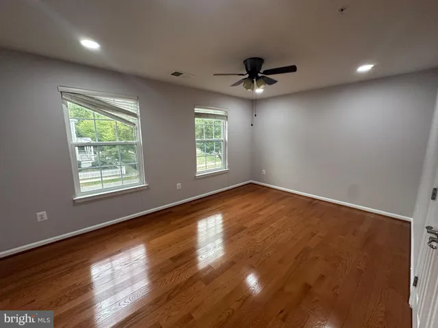 a view of a livingroom with wooden floor and stairs