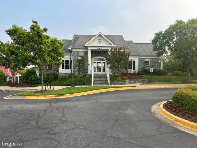 a view of a cars park in front of a building