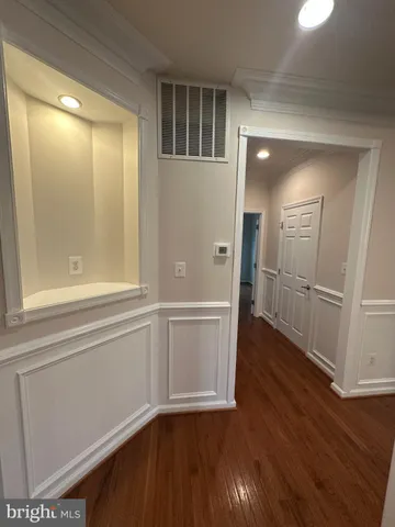 a view of a small space with wooden floor and a window