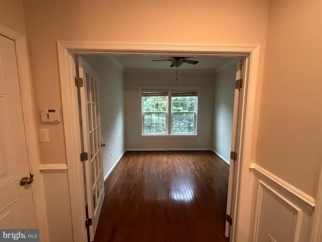 a view of empty room with wooden floor and fireplace
