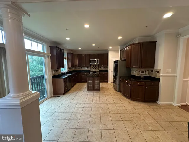 a kitchen with stainless steel appliances a sink stove and refrigerator