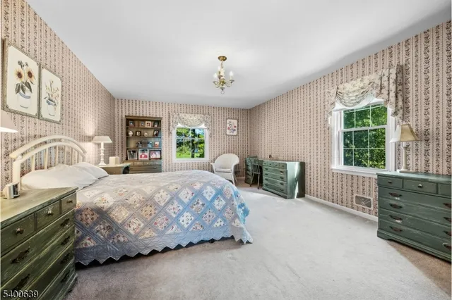 a spacious bedroom with a bed and a large window