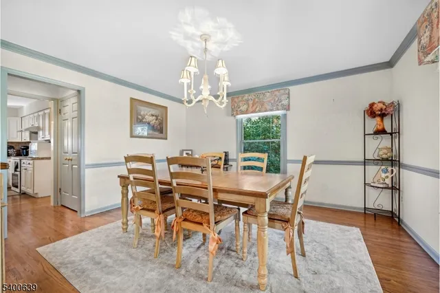 a view of a dining room with furniture wooden floor and chandelier