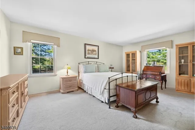 a spacious bedroom with a bed and a window