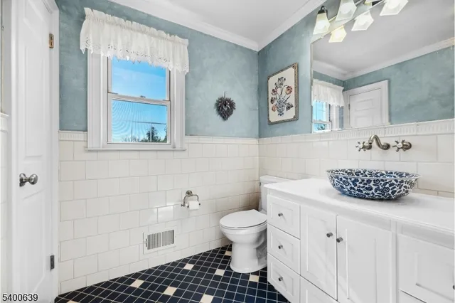 a bathroom with a toilet a sink and a mirror