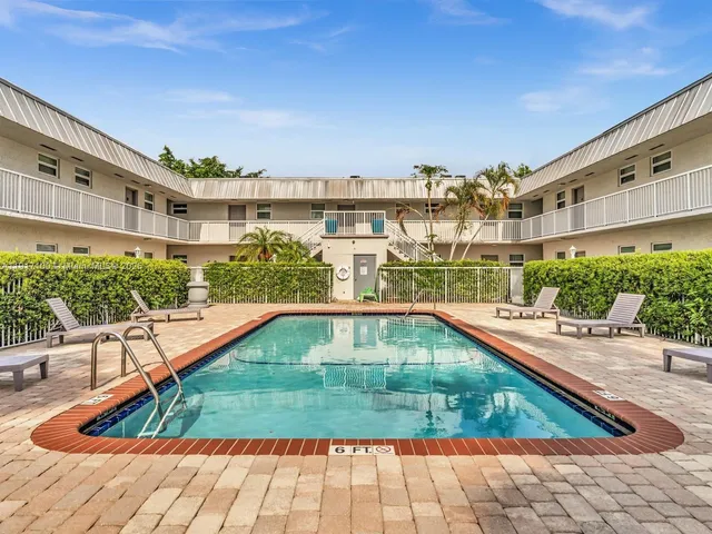 a view of swimming pool with a lounge chair