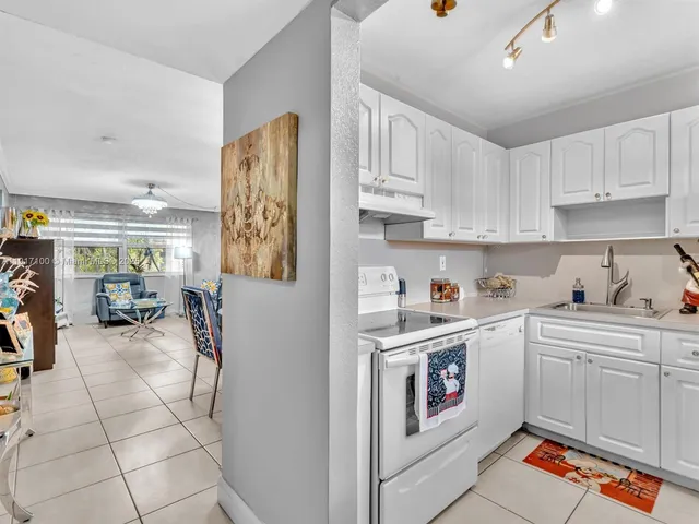 a kitchen with a sink cabinets and window
