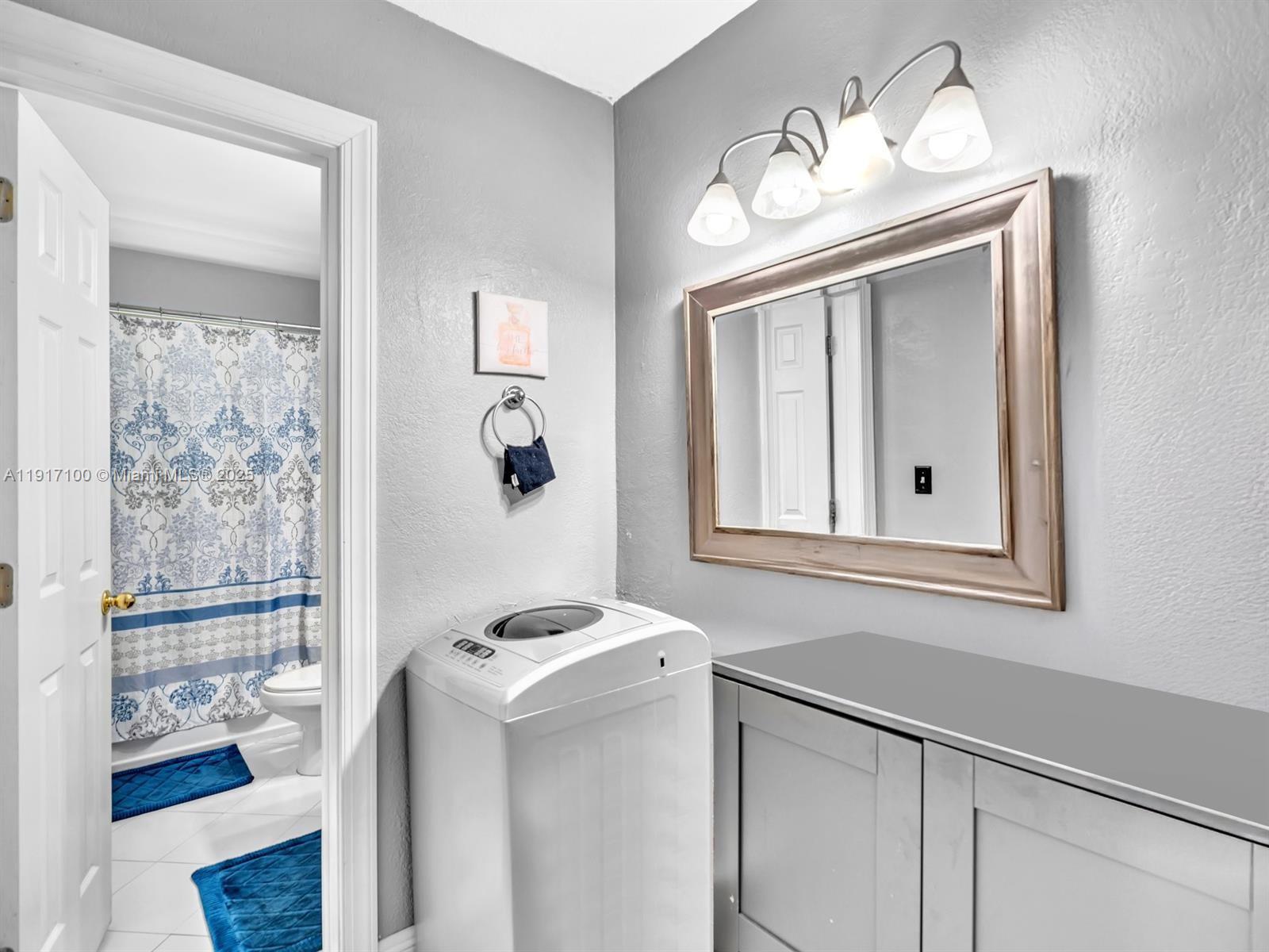 2050 Northwest 89th Avenue, Unit 211 Pembroke Pines, FL 33024 - Photo 10 of 14 a bathroom with a sink mirror and vanity