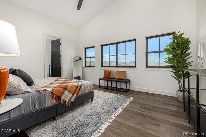 634 Lower Ranch View Road Granby, CO 80446 - Photo 39 of 50 a bedroom with bed and a potted plant