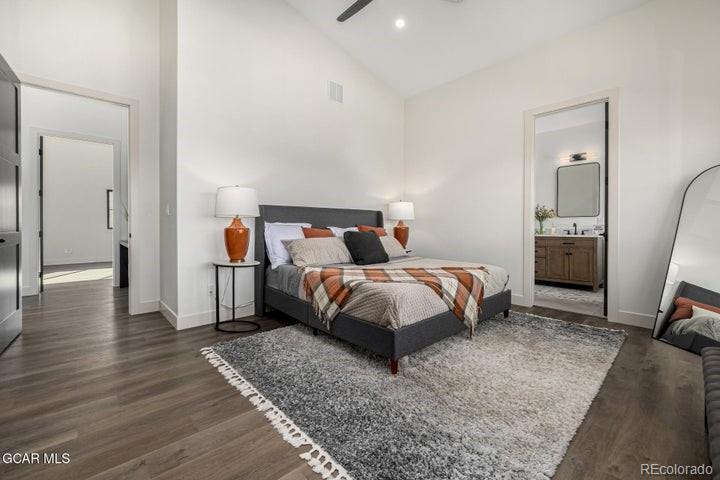 634 Lower Ranch View Road Granby, CO 80446 - Photo 40 of 50 a bedroom with a bed and wooden floor