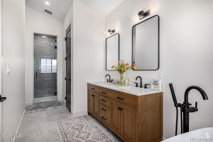 634 Lower Ranch View Road Granby, CO 80446 - Photo 45 of 50 a bathroom with a double vanity sink and a mirror