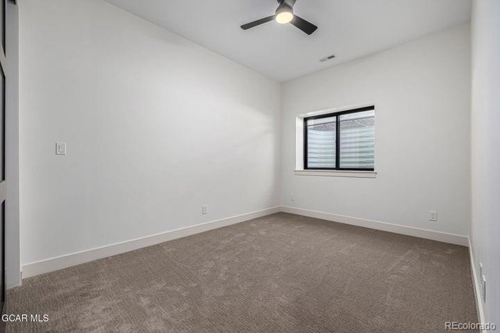 634 Lower Ranch View Road Granby, CO 80446 - Photo 46 of 50 an empty room with a empty space and windows