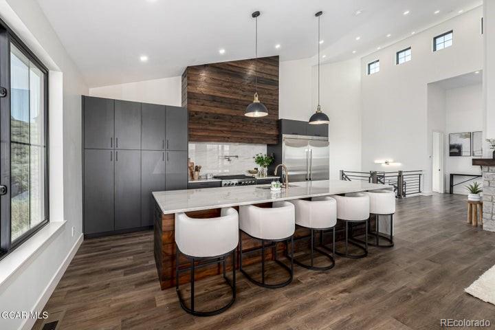 634 Lower Ranch View Road Granby, CO 80446 - Photo 10 of 50 a dining hall with stainless steel appliances kitchen island a table chairs and a refrigerator