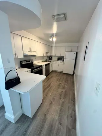 a kitchen with wooden cabinets and white appliances