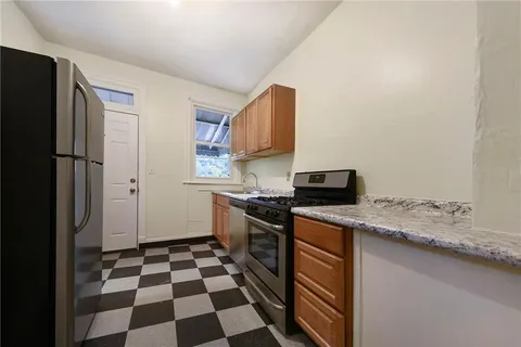 a kitchen with a stove a sink and a refrigerator