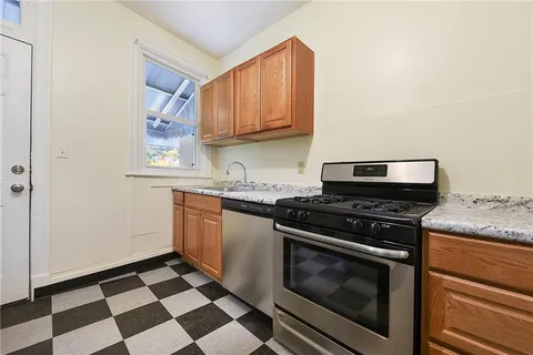 a kitchen with stove and cabinets