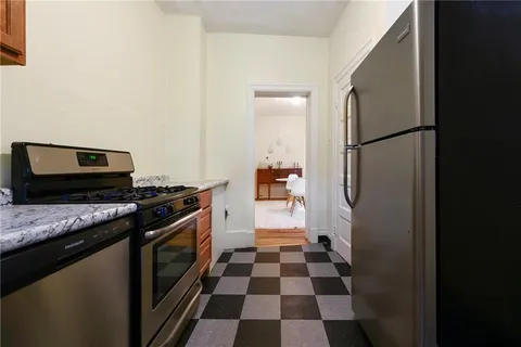 a kitchen with a stove a sink and a refrigerator