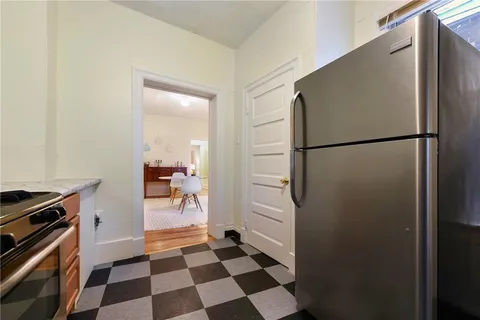a kitchen with a refrigerator and a stove