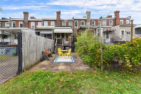 a view of a house with backyard and porch