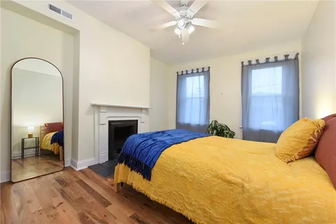 a bedroom with a bed and a chandelier