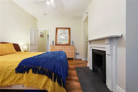 a bedroom with a bed and a fireplace