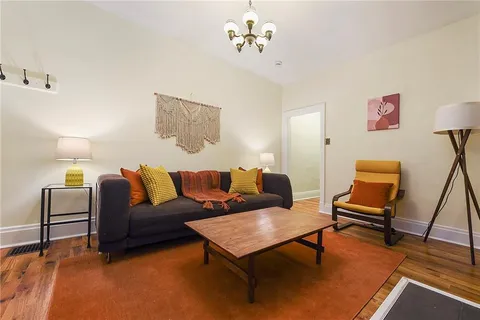 a living room with furniture and a rug