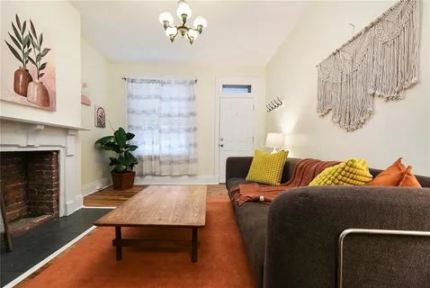 a living room with furniture and a fireplace