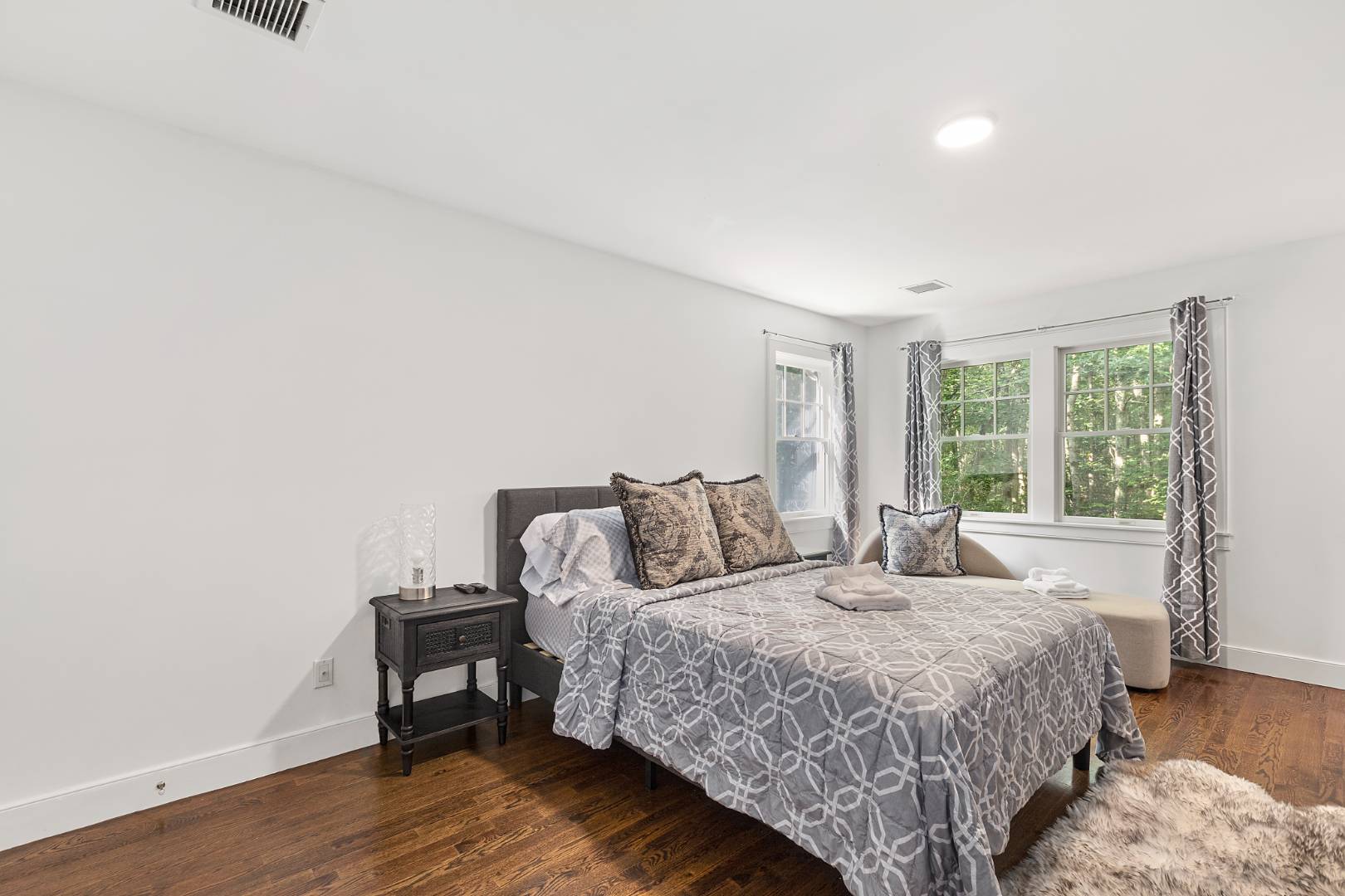 25 Old Sag Harbor Road Bridgehampton, NY 11963 - Photo 13 of 19 a bedroom with a bed and wooden floor